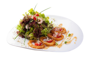 Mix salads with fried squid rings and shrimps with oyster sauce. On white background