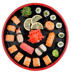 Sushi Set nigiri, rolls and sashimi served in traditional Japan black Sushioke round plate. On...