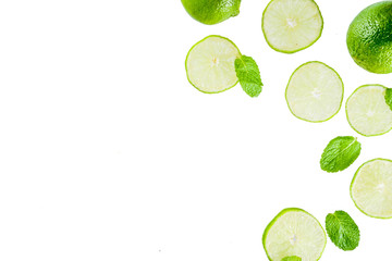 Fototapeta na wymiar Fresh lime slice with mint leaves isolated on white background, top view copy space. Summer refreshment cocktail ingredient concept.