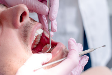 Dentist examining a patient's teeth in the dental office.