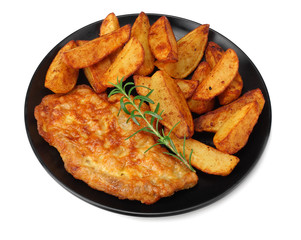 Fried potato wedges with schnitzel on black plate isolated on white background
