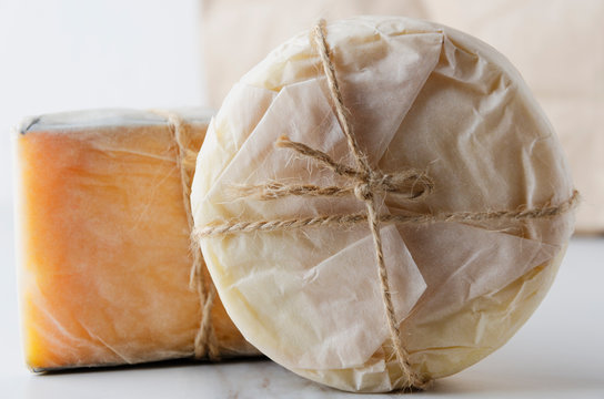 Close up of fresh wrapped in paper cheese.Traditional italian cheese.Various typies of cheese
