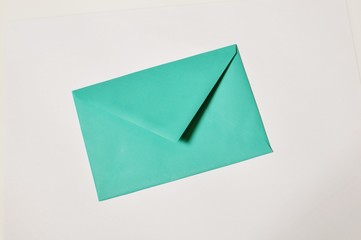 Top table of an closed green envelope on white background