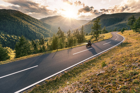 Fototapeta Motorcycle driver riding in Alpine road