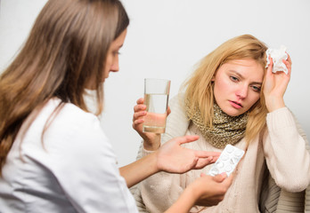 Obraz na płótnie Canvas Woman consult with doctor. Girl in scarf hold tissue while doctor offer treatment. Cold and flu remedies. Tips how to get rid of cold. Recognize symptoms of cold. Remedies should help beat cold fast