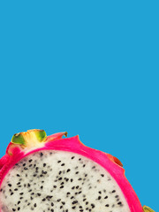 Exotic dragon fruit isolated on blue background, macro. Section of a ripe pitahaya or pitaya, texture. Sweet juicy tropical fruit surface. Fruit of cactus, hylocereus, cactaceae