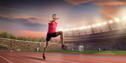 Male athlete sprinting. Men in sport clothes run at the running track in professional stadium