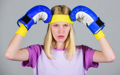 Beat headache. Girl boxing gloves tired to fight. Strong woman suffer pain. Girl painful face...