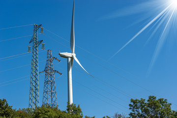 Obraz premium Wind Turbine and High voltage towers
