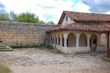 Fototapeta na wymiar Old houses with tiled roofs. View from the yard. Chufut Kale, a cave city in Crimea from the 5th century