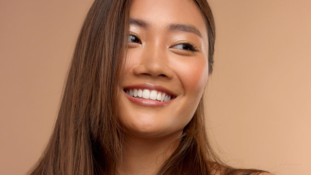 wide smiling thai asian japanese model watching aside