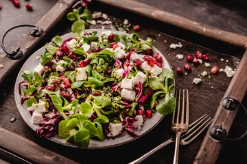 Foto op Plexiglas fresh winter salad with pomegranate seeds © Fischer Food Design