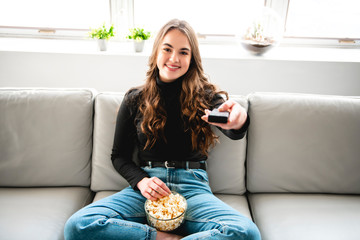 A Teenage Girl Relaxing At Home Watching Television