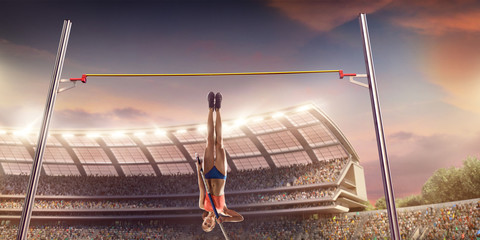 Young female pole vault athlete with pole bar. Women in sport clothes jump over the pole bar at athletic sport track in professional stadium