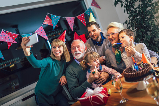 Family Celebrating Grandfather's Birthday Together And Make Selfie Photo.