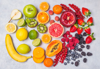 Fruits and berries rainbow colors top view background.Vitamins and antioxidants healthy food concept.
