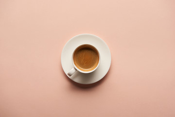 top view of tasty espresso in white cup on pink background