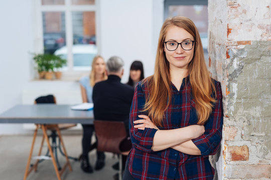 Confident young businesswoman with folded arms