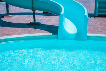 Stylishly interesting water slide in the pool near the sea on nature background