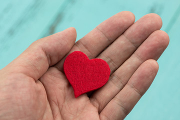 Red heart in hand, valentine's background