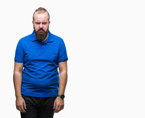 Young caucasian hipster man wearing blue shirt over isolated background skeptic and nervous, frowning upset because of problem. Negative person.