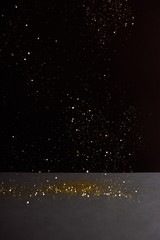Obraz na płótnie Canvas grey stone table with bright sparkles isolated on black
