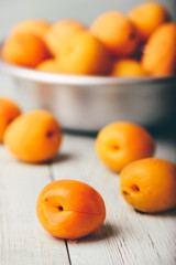 Mellow apricots over light wooden surface