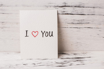 I love you greeting card on wooden table, valentine's background