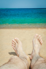 Stylish beautiful legs on the sea shore background