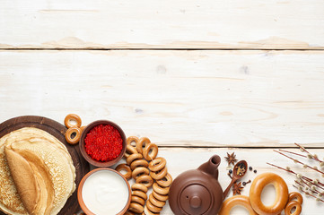 A Russian Tea Party including thin pancake blini, red caviar, sour cream and bagels