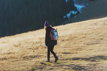 The girl walks in the mountainous valleys.