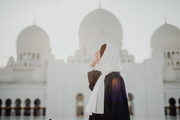 Female tourist visiting at Sheikh Zayed Grand Mosque in Abu Dhabi