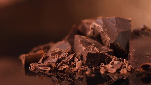 Chocolate. Chunks of sweet dark chocolate rotated closeup. Dessert ingredient. Confectionery. Rotation. 4K UHD video 3840X2160