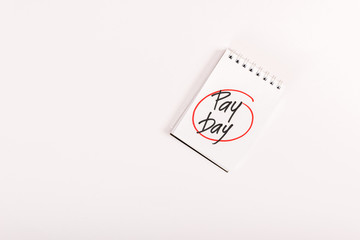 top view of notebook with 'pay day' lettering isolated on white