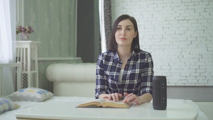 portrait a blind, visually impaired beautiful young woman reads a book, uses a voice