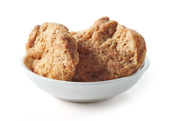 Bowl of soya chunks on white background