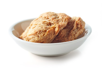 Bowl of soya chunks on white background