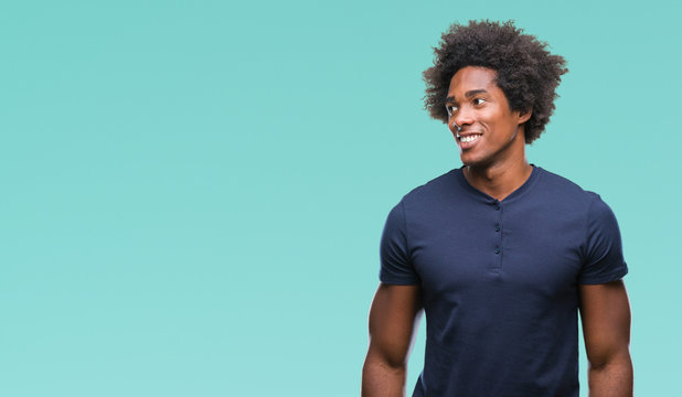 Afro american man over isolated background looking away to side with smile on face, natural expression. Laughing confident.