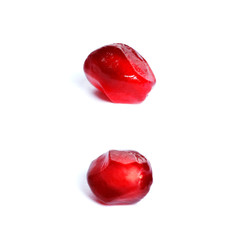 Seeds of a ripe red pomegranate closeup isolated on white background.