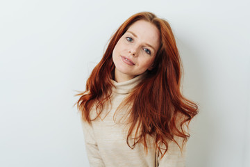 Young redhead woman looking calmly at the camera