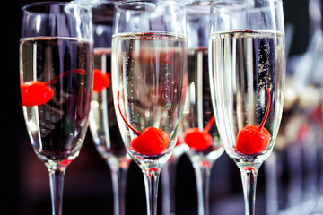 glasses with champagne and cherry. Outside guest reception