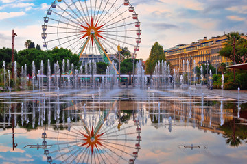 Nice ferris wheel and cityscape fountain mirror view