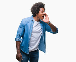 Afro american man over isolated background shouting and screaming loud to side with hand on mouth. Communication concept.