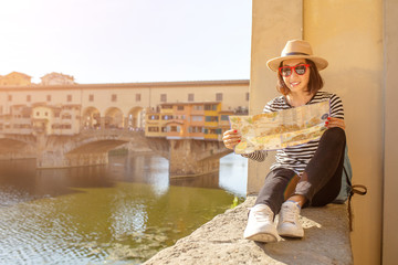Happy traveler asian women on a vacation in Florence admiring view at the Ponte Vecchio famous...