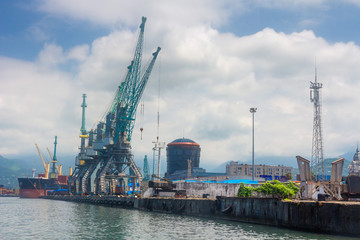Obraz premium Sea port with cargo cranes. Container terminal in dockyard.