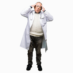 Fototapeta premium Handsome senior doctor man wearing medical coat with hand on head for pain in head because stress. Suffering migraine.