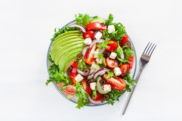 greek style avocado tomato salad with feta cheese, olives, cucumber, onion, lettuce