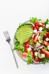 greek style avocado tomato salad with feta cheese, olives, cucumber, onion, lettuce