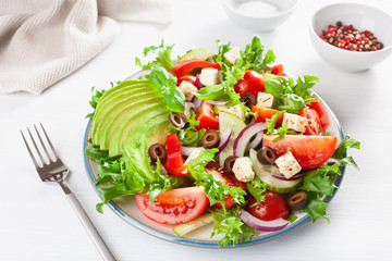 greek style avocado tomato salad with feta cheese, olives, cucumber, onion, lettuce