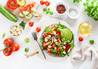 greek style avocado tomato salad with feta cheese, olives, cucumber, onion, lettuce
